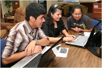 students gathered around a computer. Starting a new university can be challenging. In addition to new classes, new peers and new faculty, you also need to learn how to navigate through CSUEB's online world. (By: YHC.edu)